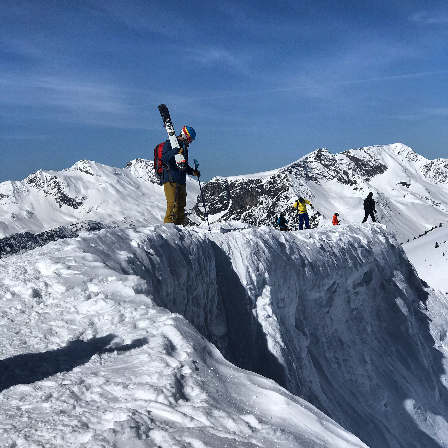 Skier making a steep drop during a guided backcountry ski trip in Canada