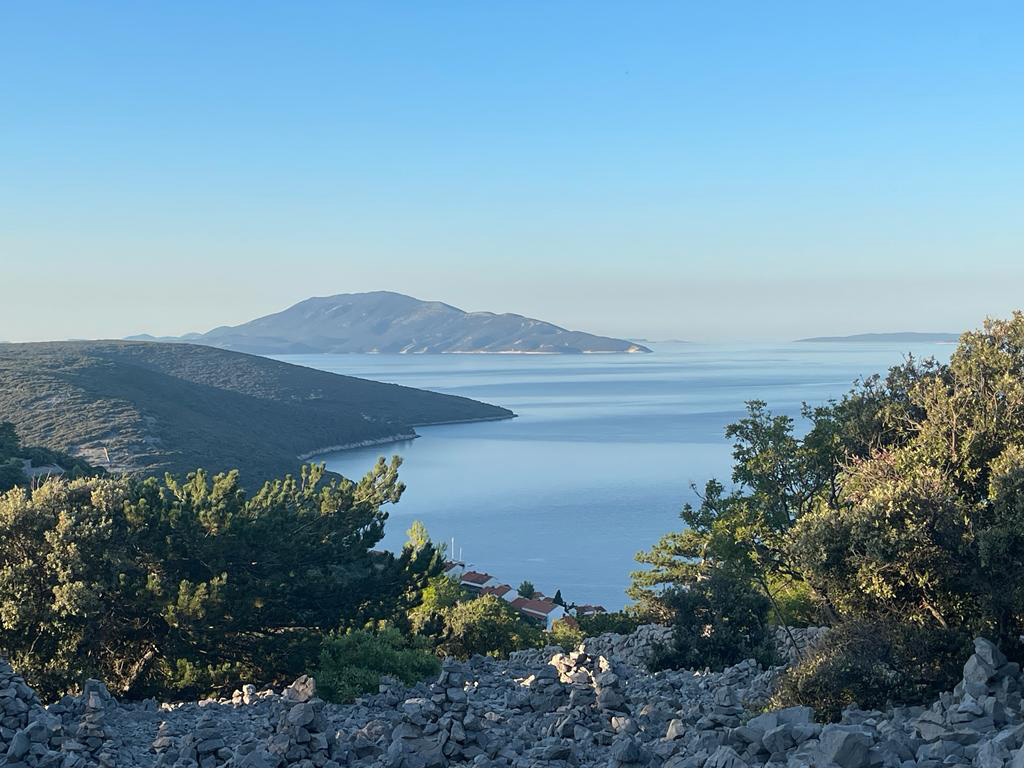 Mountain biker overlooking the coastline during a trip on Cres Island, Croatia
