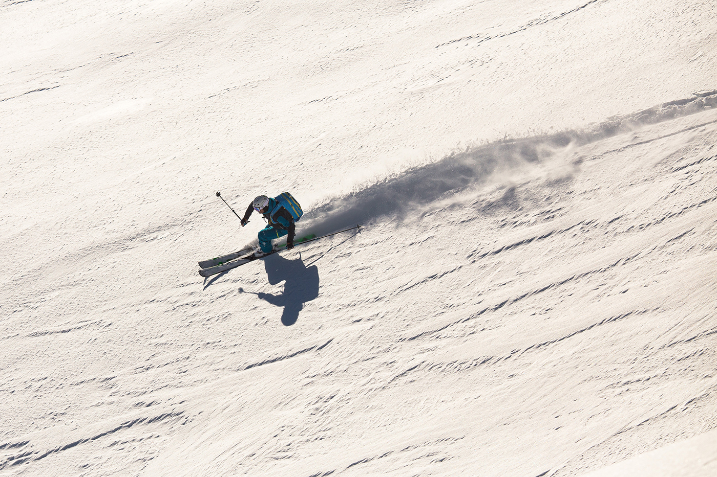 Skier descending pristine powder slopes during a PerfectRide ski trip in Canada